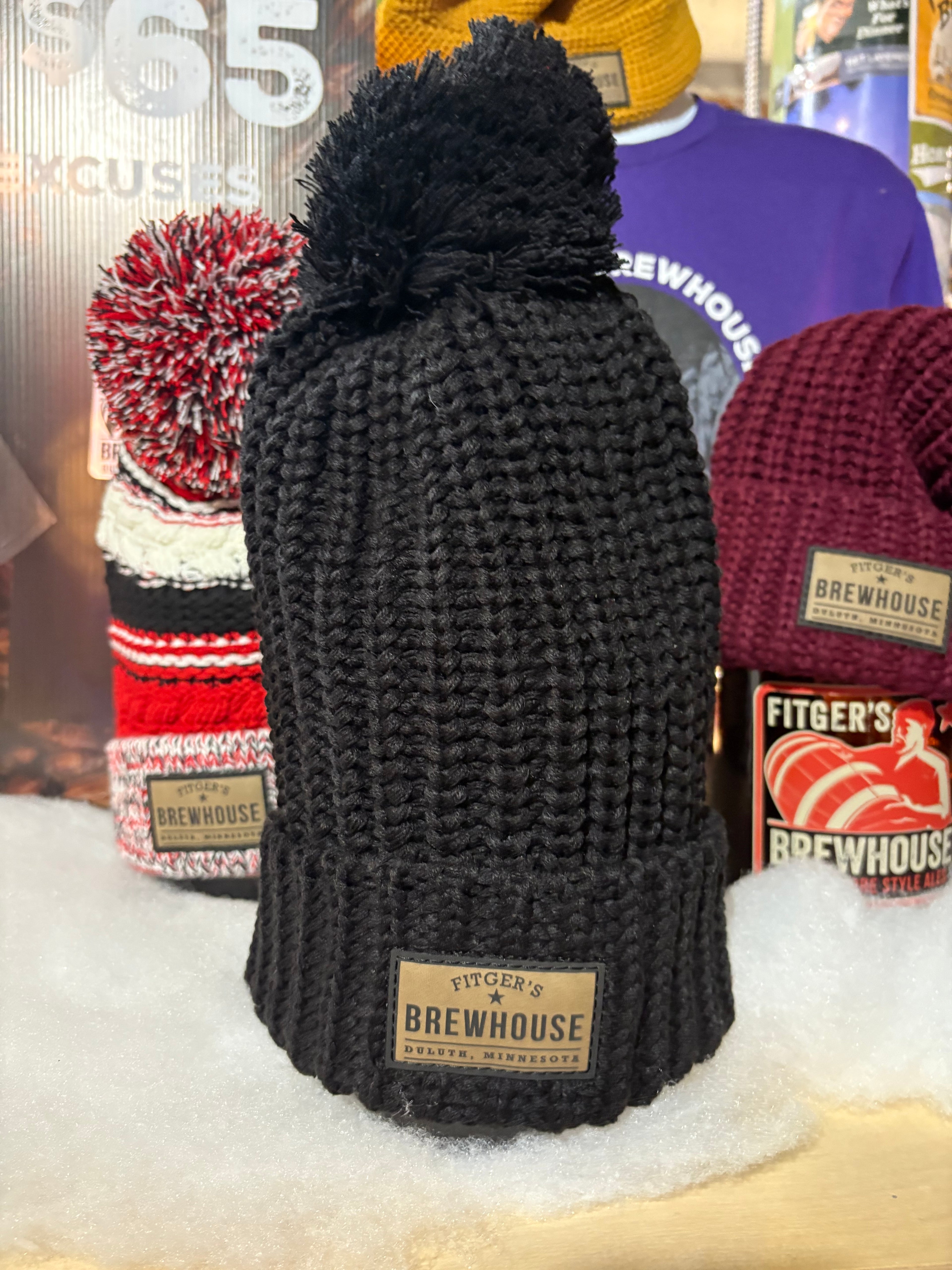 New black  Knit Hat with pom/leather Fitgers Brewhouse patch